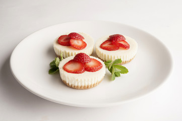 Three strawberry cheesecakes
