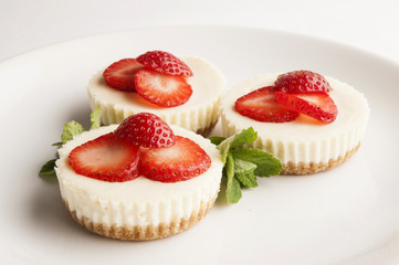 Strawberry cheesecakes on a plate close up