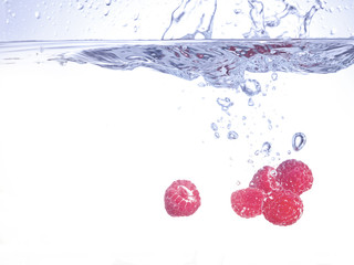 Fototapeta na wymiar ripe raspberries on water