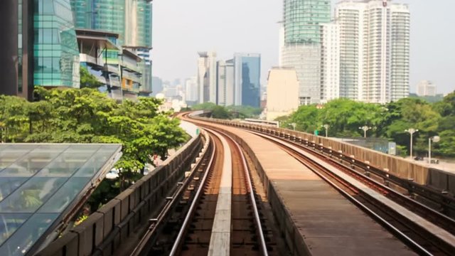Camera moves along KL Metro Rails among Skyscrapers