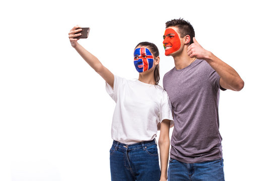Iceland vs Portugal football fans take selfie photo with phone on white background. European football fans concept.
