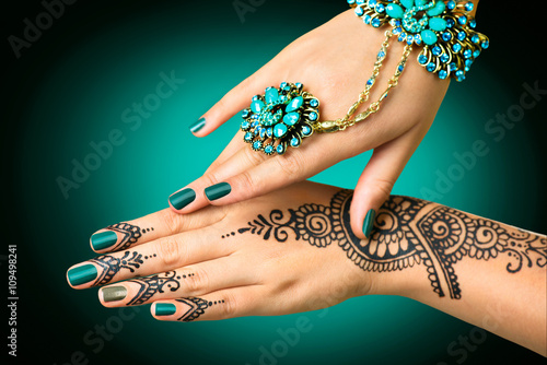 Woman\u0027s hands with mehndi tattoo. Hands of Indian bride girl