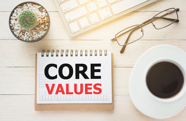 Concept CORE VALUES message on book. A keyboard and a glass coffee table.Vintage tone.