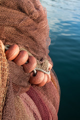 fishing net with floats, sea in background