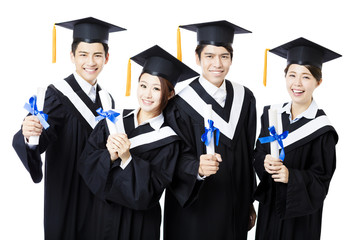 college graduates in graduation gowns standing  and smiling