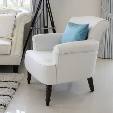 blue pillows on a white leather chair in vintage living room