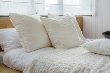 stylish bedroom interior design with black and white pillows on bed.