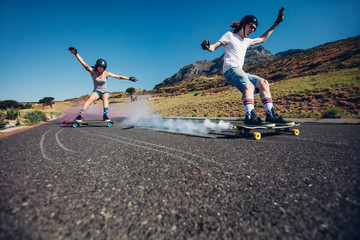 Young people longboarding down the road © Jacob Lund