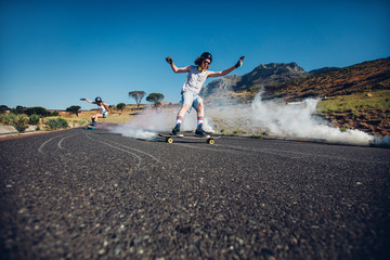 Young people skating down the street
