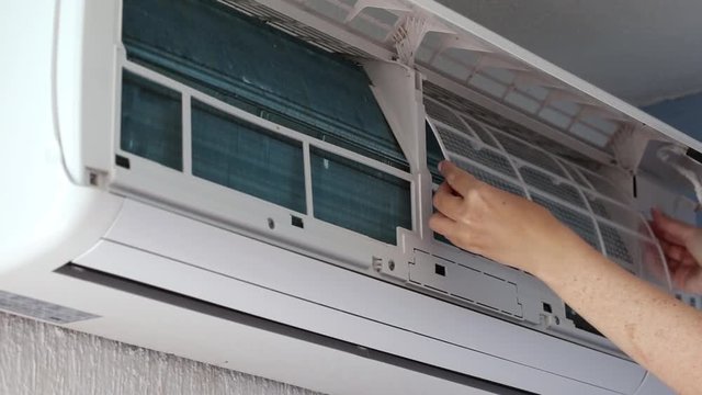 Removing dirty filter of air conditioner Split-system for cleaning and washing. Maintenance 