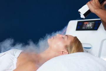 Beautiful woman getting local cryotherapy therapy