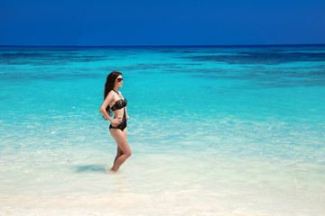 Beautiful sexy bikini model. Tropical beach. Outdoor portrait of
