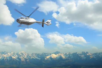 Fototapeta na wymiar Helicopter in flight over a panoramic view of Tatra mountains