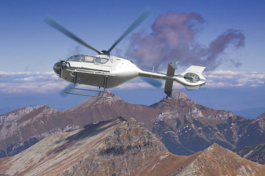 Helicopter in flight over a panoramic view of Tatra mountains