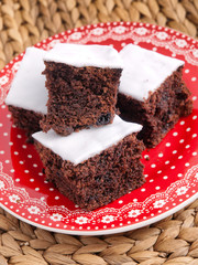 Homemade Chocolate cake cut into squares, shot from above