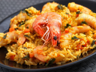 Seafood risotto with shrimps, curry and herbs. Close up.