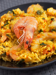 Seafood risotto with shrimps, curry and herbs. Vertical shot