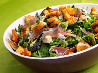French Provencal Salad with green salad, bacon, croutons and blue cheese. Tilted view.
