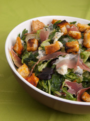 French Provencal Salad with green salad, bacon, croutons and blue cheese. Tilted view, vertical shot