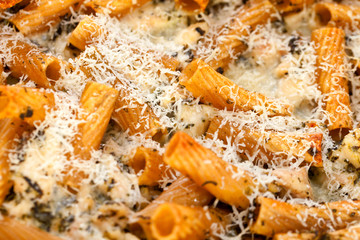 Baked Penne pasta with parmesan cheese.