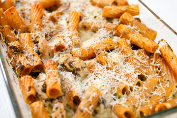 Baked Penne pasta with parmesan cheese in caserole
