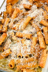 Baked Penne pasta with parmesan cheese in caserole. Shot from above. Tilted view