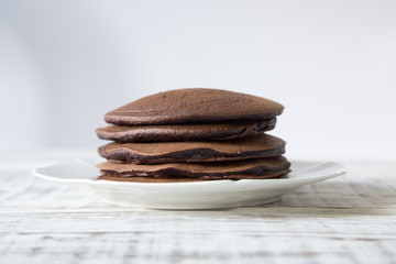 Chocolate pancake on a light background