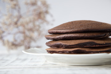 Chocolate pancake on a light background