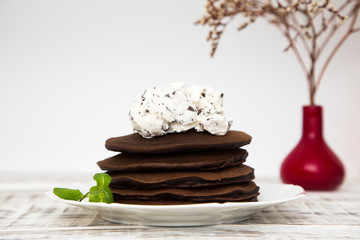 Chocolate pancake with icecream on a light background