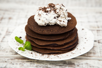 Chocolate pancake with icecream on a light background