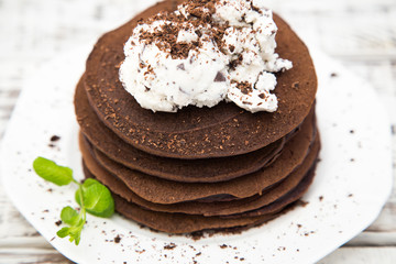 Chocolate pancake with icecream on a light background