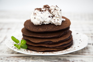 Chocolate pancake with icecream on a light background