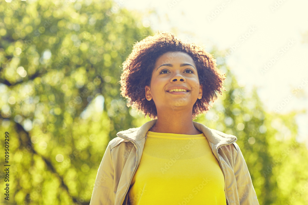 Wall mural happy african american young woman in summer park