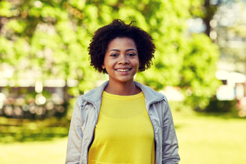 happy african american young woman in summer park