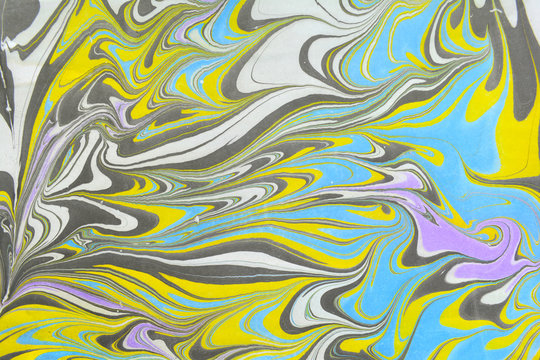Ebru art. Traditional Turkish Ebru technique. Painting on water transferred on highly textured paper or cloth. Color paint ebru with waves and tile pattern.
