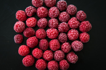 Frozen berries on dark background.