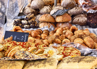 Baked goods at a bakery or market stall. Various pastries arrangement on a market stall.