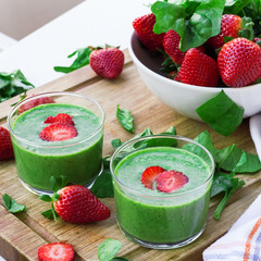 Green spinach smoothie with strawberry