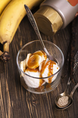 Ice cream scoops with banana slices and caramel sauce