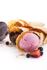 Portion of homemade berry pink ice cream and waffle cones