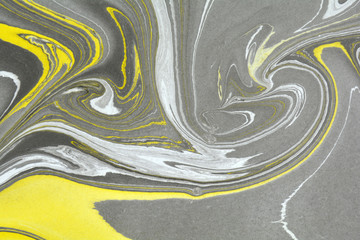 Abstract background. Ink marbling texture. Grey, yellow and white. Hand drawn marble illustration, ebru aqua paper and silk print. Traditional Turkish ebru technique. Painting on water. 