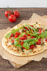 Tarte flambee, an alsatian pizza, with tomatoes and arugula