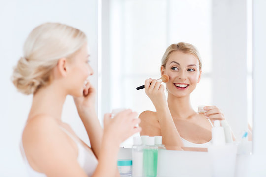 Woman With Makeup Brush And Powder At Bathroom