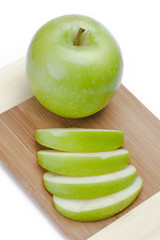 green apple on cutting board