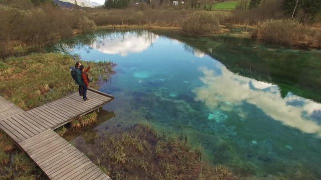 Two beautiful backpackers amaze in the beautiful view