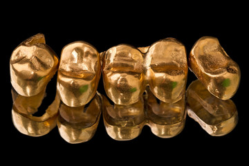Gold dental crowns on black