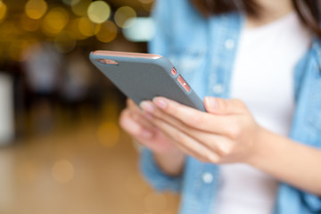 Woman sending text message on mobile phone