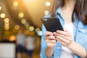 Woman sending text message on cellphone