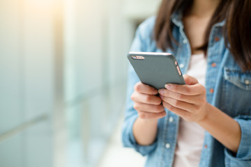 Woman sending text message on phone