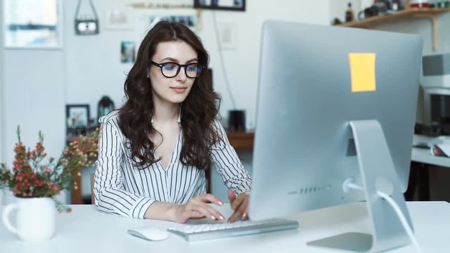 Happy hispanic young woman using tablet computer at office or school